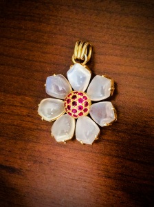 Pictured above: 14k yellow gold Moonstone Ruby Flower Pendant- Circa 1940 - Available at Robert’s Jewelers.